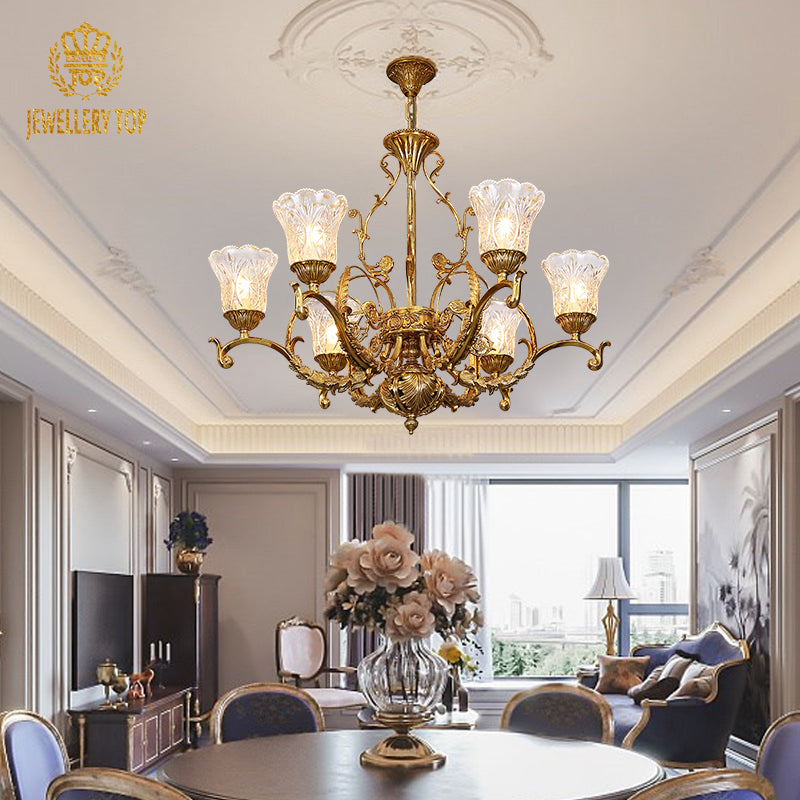 A royal luxury chandelier installed in a lavish dining room with ornate ceiling moldings and sumptuous furnishings.