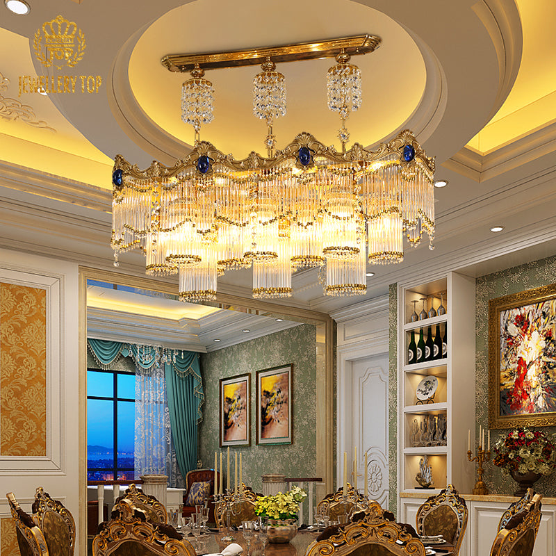 A luxurious dining room featuring the large rectangular brass chandelier hanging above an ornate dining table set for a banquet.