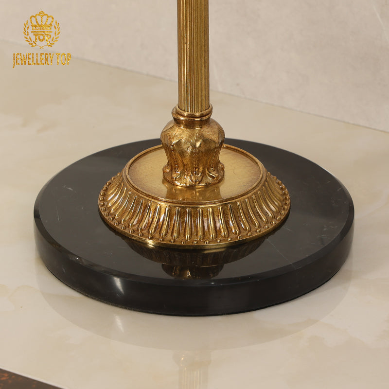 Close-up detail of the heavy black marble base and fluted brass pedestal footing by Jewellery Top.