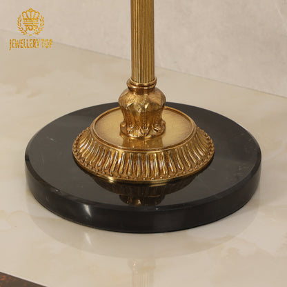 Close-up detail of the heavy black marble base and fluted brass pedestal footing by Jewellery Top.