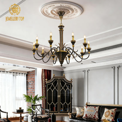 JEWELLERY TOP brass chandelier in a grey living room with a red brick wall and sofa.