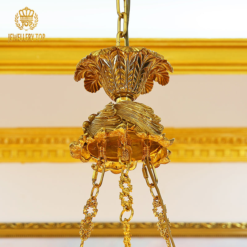 Macro close-up of the finely detailed golden acanthus leaf embellishments and the sculpted rose motifs.