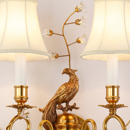 Macro shot of the crystal-accented brass leaves and the sparkling droplet pendants on the wall lamp.