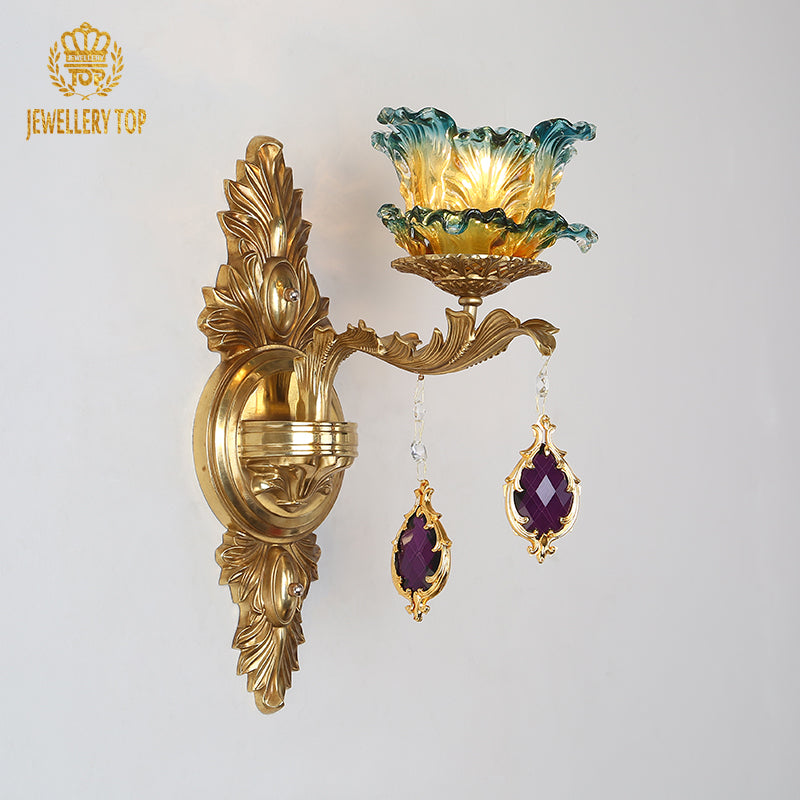 Close-up front view of the decorative wall lamp, showcasing the intricate brass scrollwork and purple crystal drops.