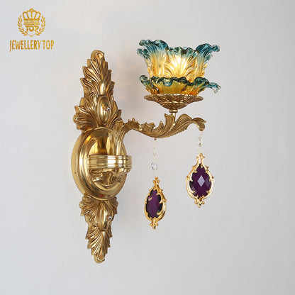 Close-up front view of the decorative wall lamp, showcasing the intricate brass scrollwork and purple crystal drops.