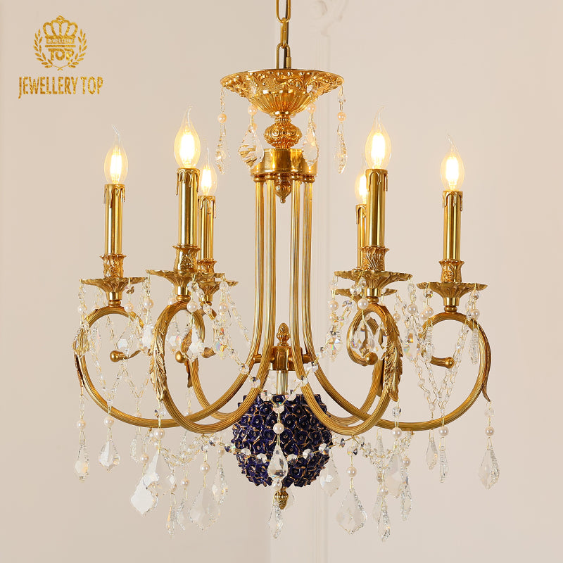 Macro close-up of the finely detailed golden acanthus leaf embellishments and the crystal drop accents.