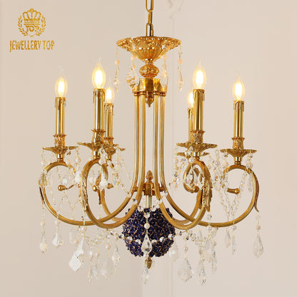 Macro close-up of the finely detailed golden acanthus leaf embellishments and the crystal drop accents.