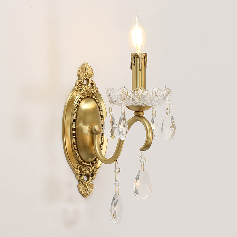 The gold wall light mounted on a white wall, showcasing its elegant profile and warm illumination.