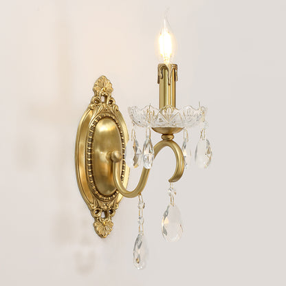 The gold wall light mounted on a white wall, showcasing its elegant profile and warm illumination.