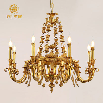 A lit antique-style brass chandelier with a bird ornament, brand JEWELLERY TOP visible.