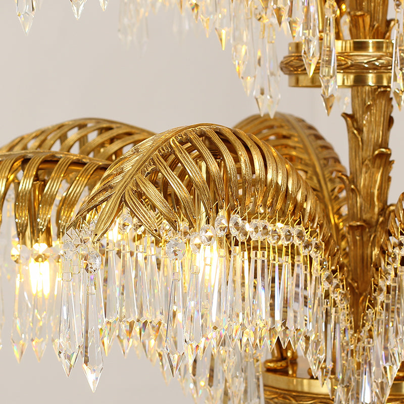 Macro close-up of the finely detailed palm leaf carvings and the rich golden texture of the solid brass frame.