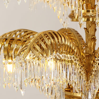 Macro close-up of the finely detailed palm leaf carvings and the rich golden texture of the solid brass frame.