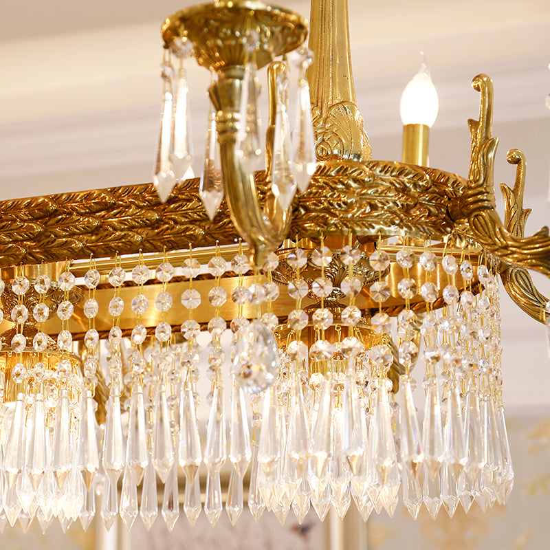 Extreme close-up of ornate brass engraving and sparkling teardrop crystal pendants.