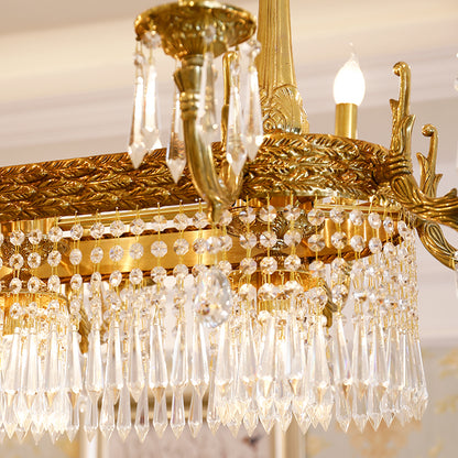 Extreme close-up of ornate brass engraving and sparkling teardrop crystal pendants.