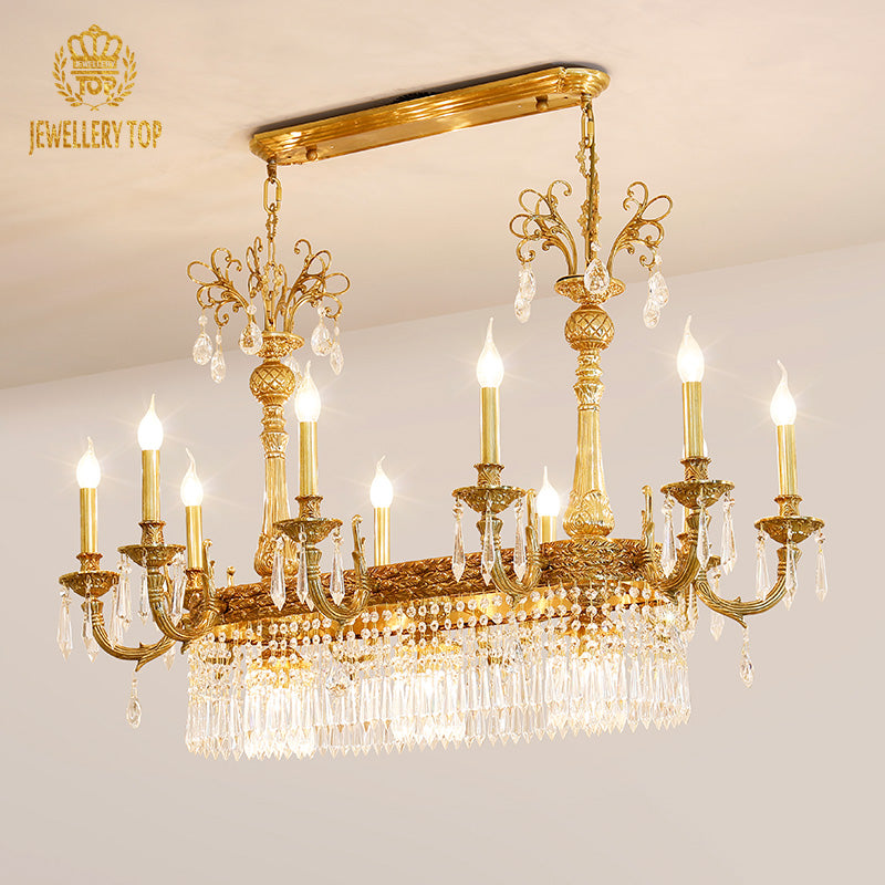Front view of a JEWELLERY TOP classical brass chandelier with intricate curved arms and crystals.