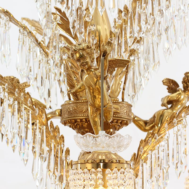 Extreme close-up of a detailed brass cherub figurine and crystal pendants on the chandelier.