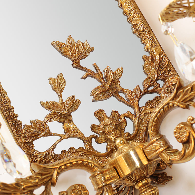 Extreme macro detail of the hand-chased brass acanthus leaf and classical figure浮雕 carvings on the sconce frame.