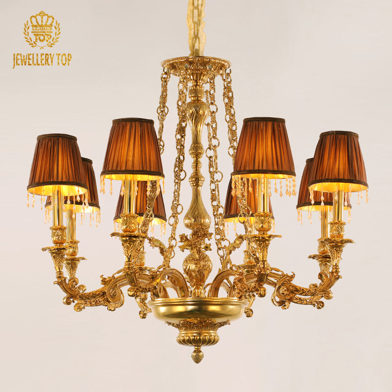 JEWELLERY TOP French brass chandelier with dark fabric shades and tassels on black background.