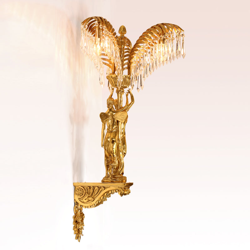 Detailed close-up of the two ascending angel sculptures with wings, clinging to the ornate central brass column.