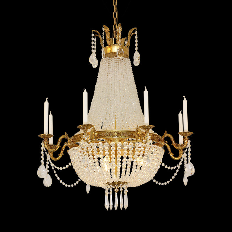 French Baroque brass chandelier with a conical crystal centerpiece, isolated on black.