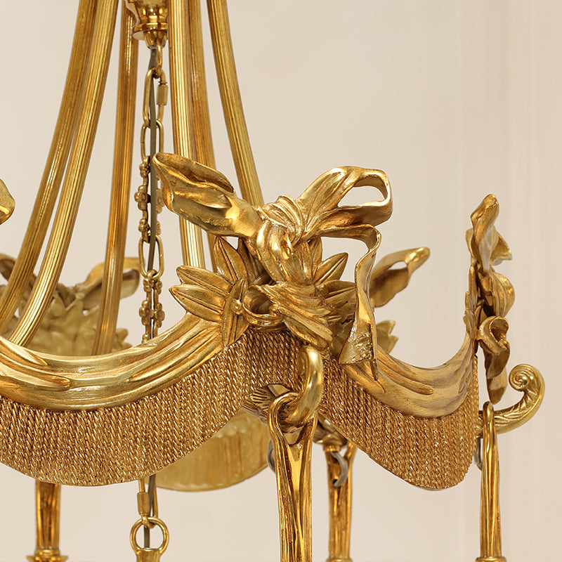 Extreme detail shot focusing on the top crown of the chandelier, featuring the winged goddess and acanthus leaf motifs.