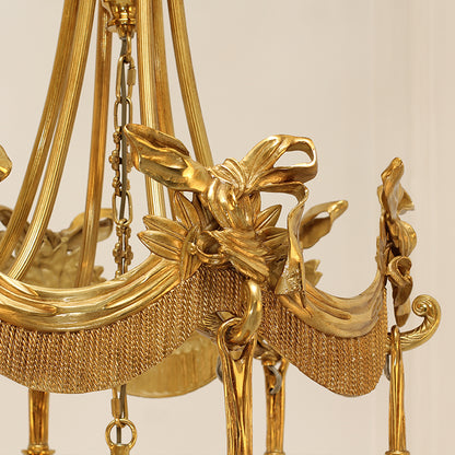 Extreme detail shot focusing on the top crown of the chandelier, featuring the winged goddess and acanthus leaf motifs.