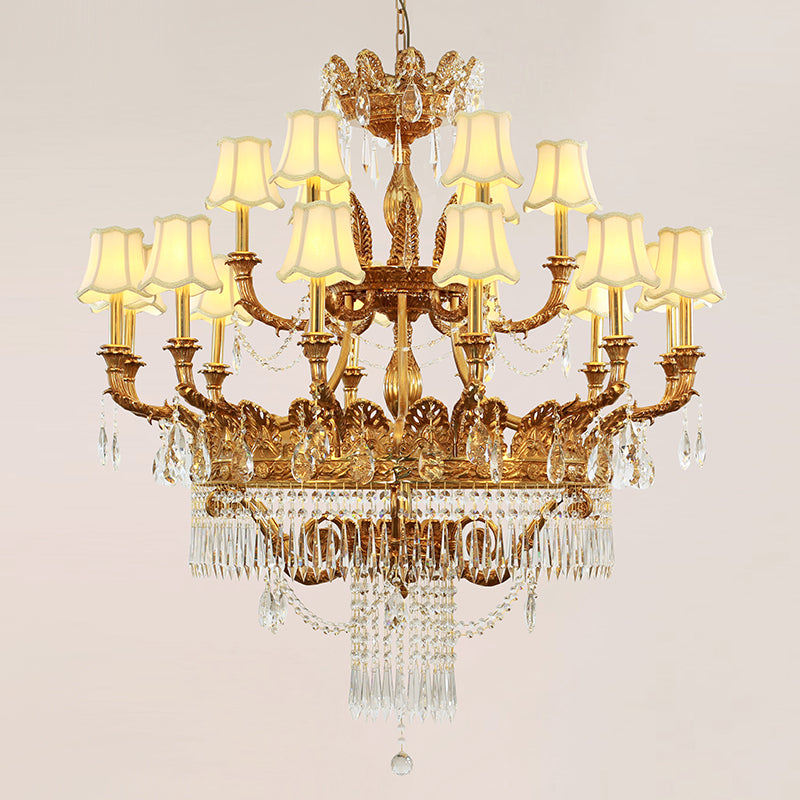 Front view of a golden French brass chandelier with beige lampshades and crystal decorations.