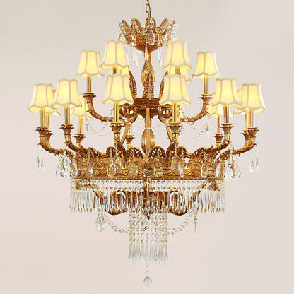 Front view of a golden French brass chandelier with beige lampshades and crystal decorations.