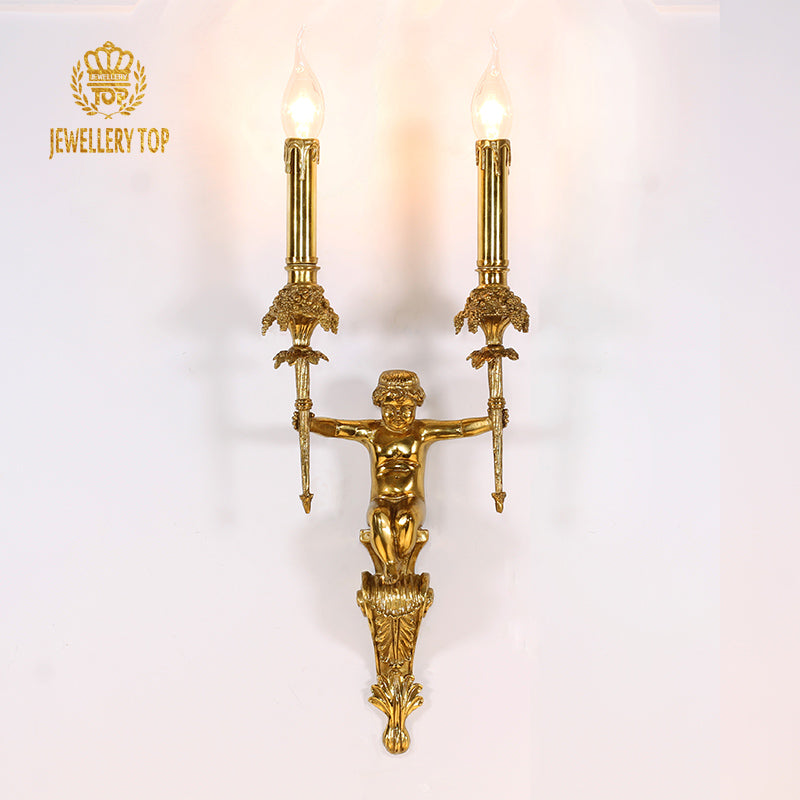 Close-up of the JEWELLERY TOP branded brass wall lamp, showcasing the angel figure and ornate arms on a white backdrop.