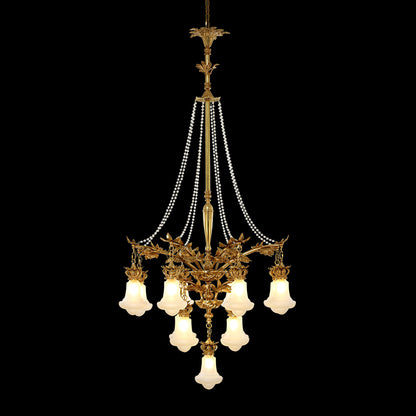 A golden antique brass chandelier with multiple pearl bead curtains, isolated on black.