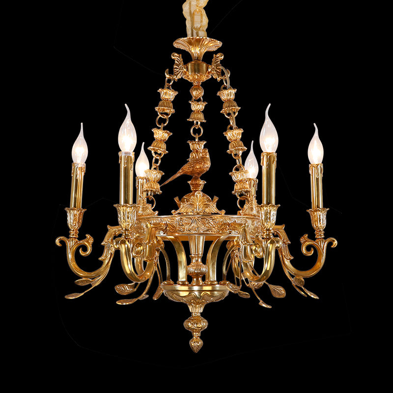 Close-up of Oiseau d'Éternité brass chandelier with bird figurine and white shades on black.