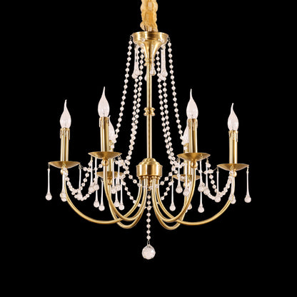Full-length studio shot of the French Empire simplified elegance brass and crystal chandelier glowing against a stark black background.
