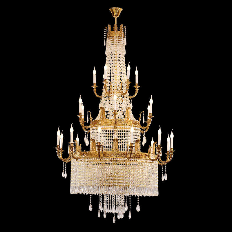 Close-up of a multi-tiered Baroque brass chandelier with dense crystal fringe on black background.