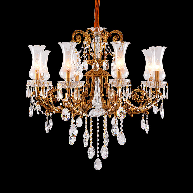 JEWELLERY TOP brand's ornate brass chandelier featuring cascading crystal pendants and frosted glass shades.