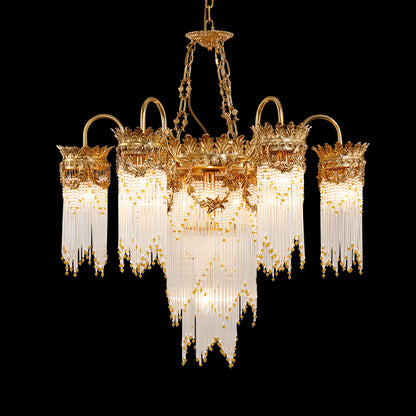 Full view of the Cascade Royale antique brass chandelier with crystal and pearl strands on black background.