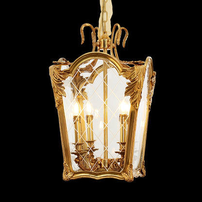 A hanging rectangular brass pendant light with clear glass and ornate carvings, viewed from below.