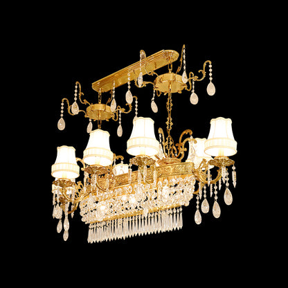 The brass dining room chandelier installed, emitting a warm glow in an elegant interior.