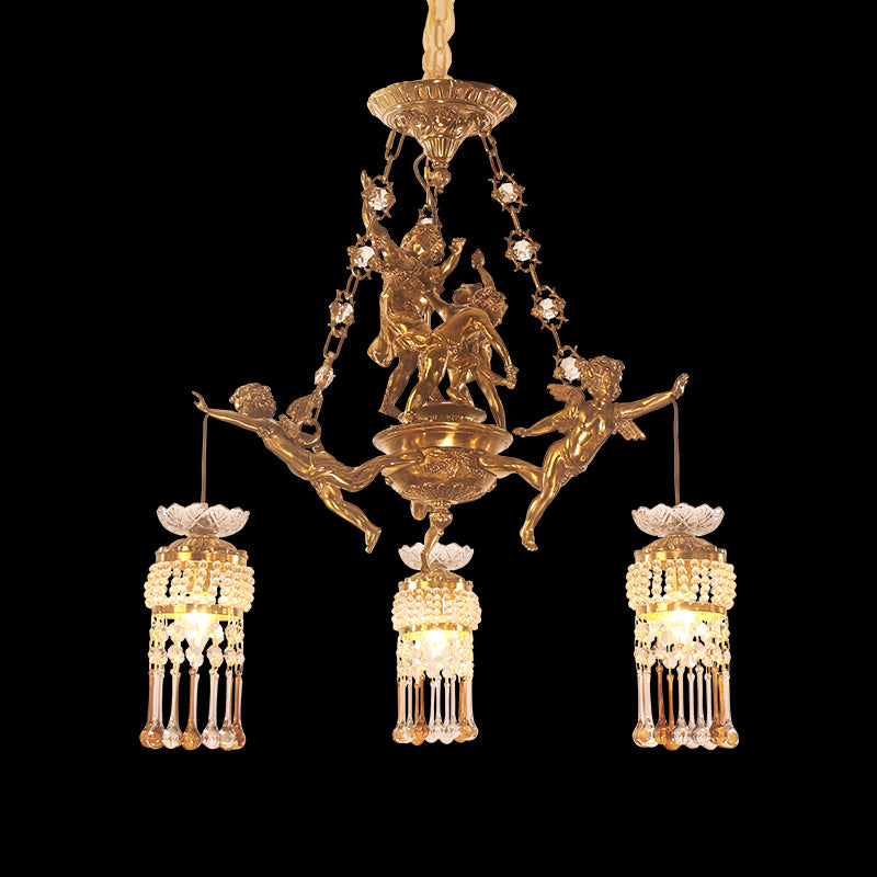 A vintage French brass chandelier with three cherub-adorned chains and crystal lamp shades.