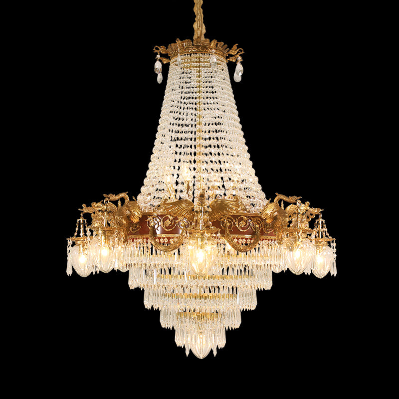 French Victorian brass chandelier with eagle decorations and layered crystal fringe on black.