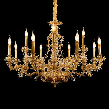 Close-up front view of an ornate brass chandelier with crystal strands and candle bulbs on black.