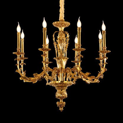Close-up detail of a golden French brass chandelier arm with intricate leaf engraving.