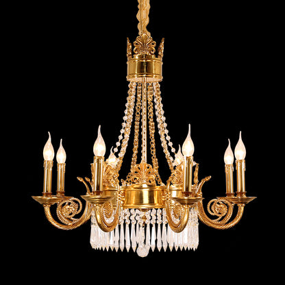 Full view of the French Neoclassical Fleur-de-Lis Motif brass chandelier glowing against a stark black background.