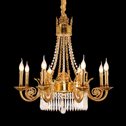Full view of the French Neoclassical Fleur-de-Lis Motif brass chandelier glowing against a stark black background.