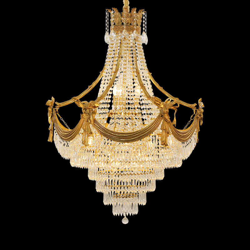 A large size luxury chandelier installed in a grand villa lobby with marble walls and a high ceiling.
