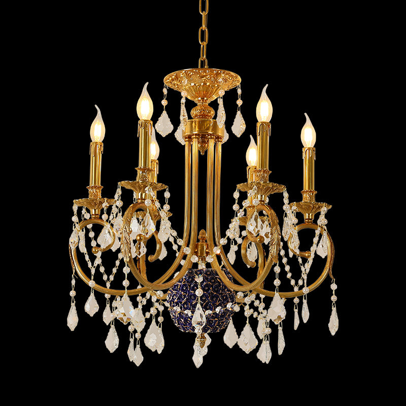 A french chandelier installed in a luxurious boutique hotel lobby with ornate wall sconces and a grand mirror.