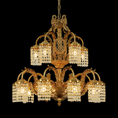Full studio shot of the French Rococo Revival style solid brass chandelier glowing against a stark black background.