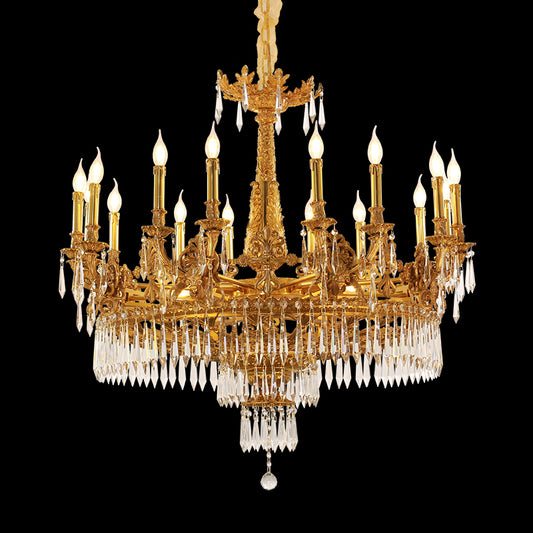 A grand multi-tiered brass chandelier with elaborate crystal pendants against a black background.