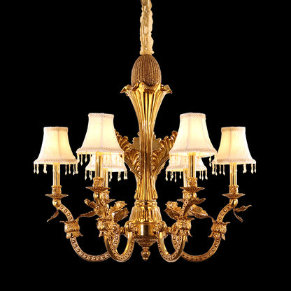 Full studio shot of the French Louis XVI floral vine brass fabric shade chandelier glowing against a stark black background.