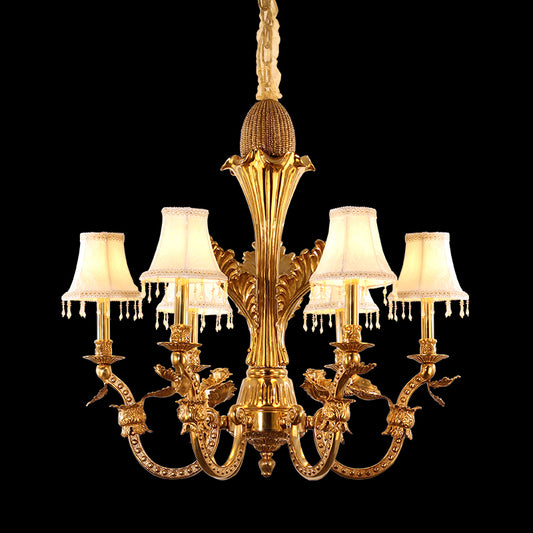 Full studio shot of the French Louis XVI floral vine brass fabric shade chandelier glowing against a stark black background.