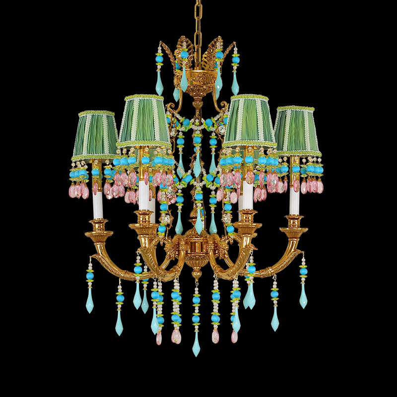 A vintage brass chandelier with multi-colored fabric shades and crystal beads on black background.